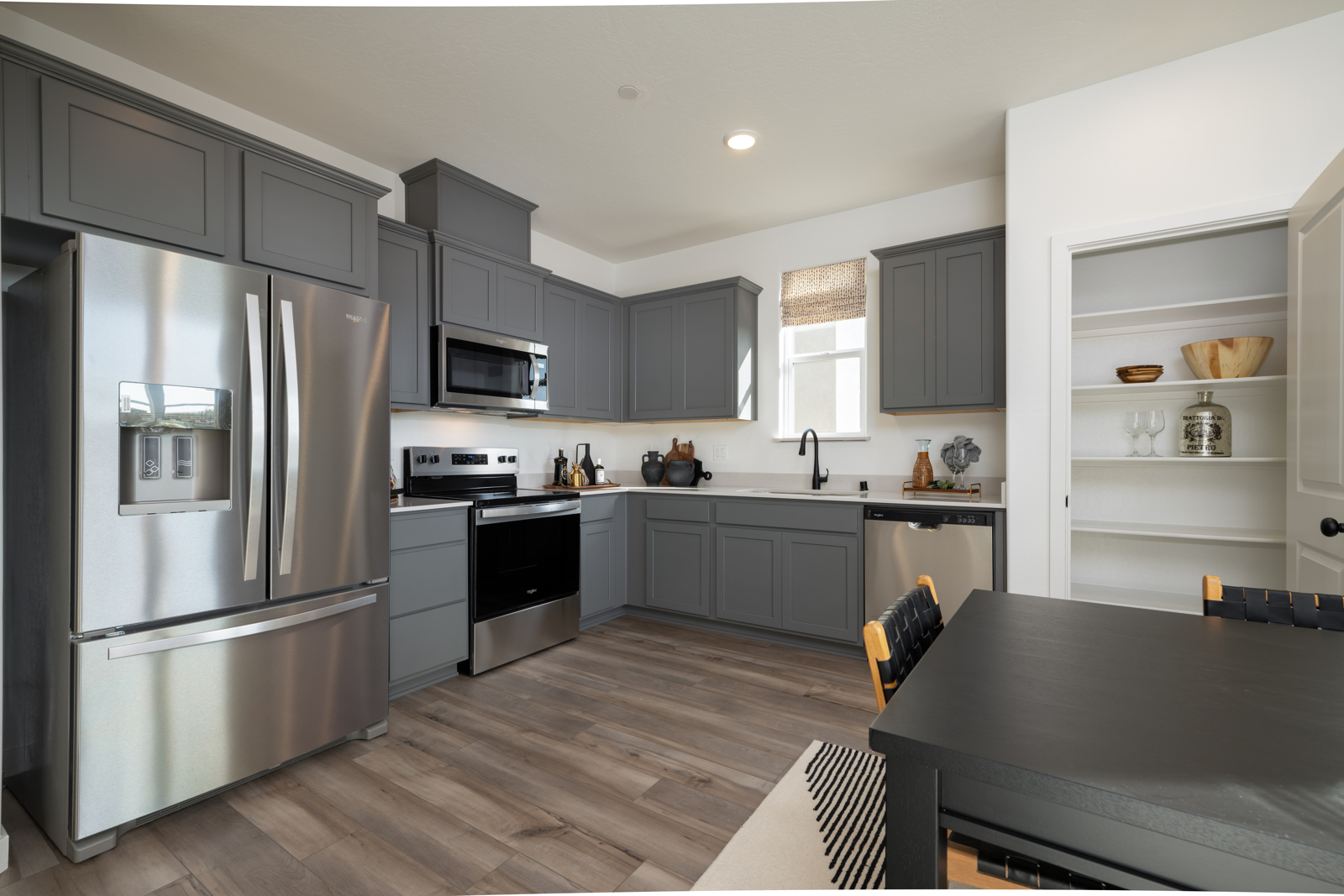 A kitchen with black cabinets.