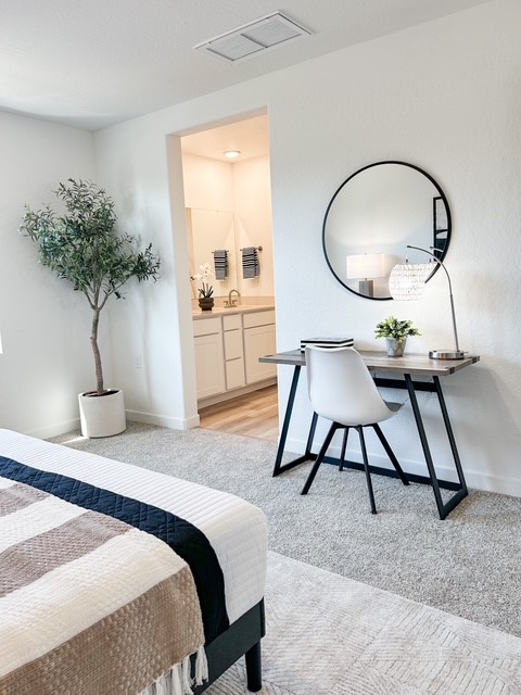 A room with a table and a mirror.