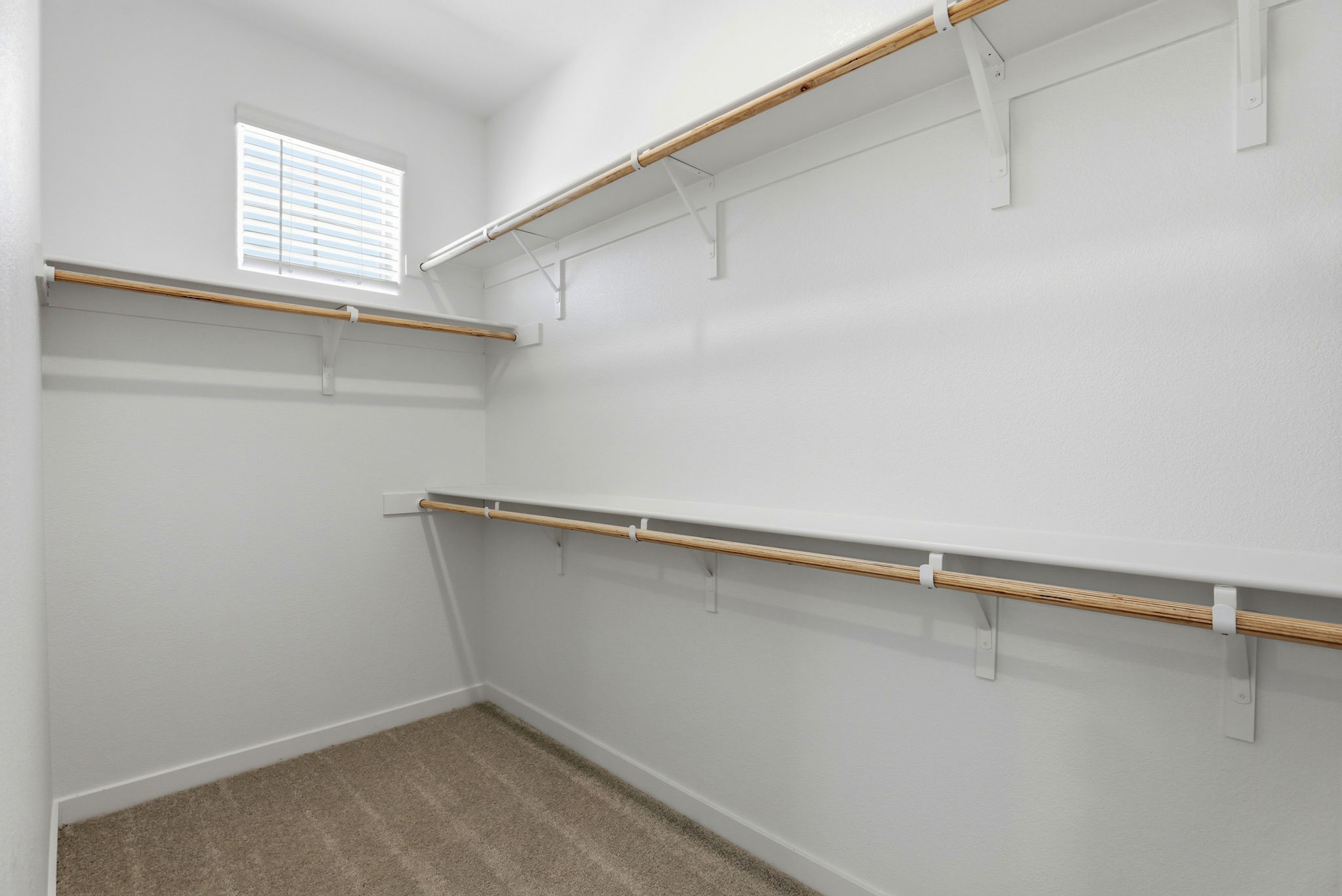 A white wall with a metal bar.