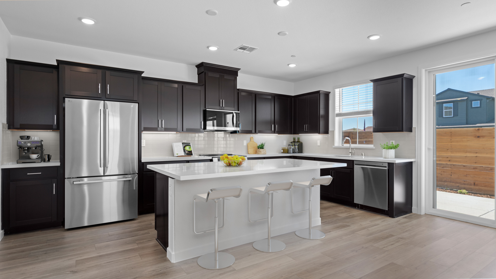 A kitchen with black cabinets.