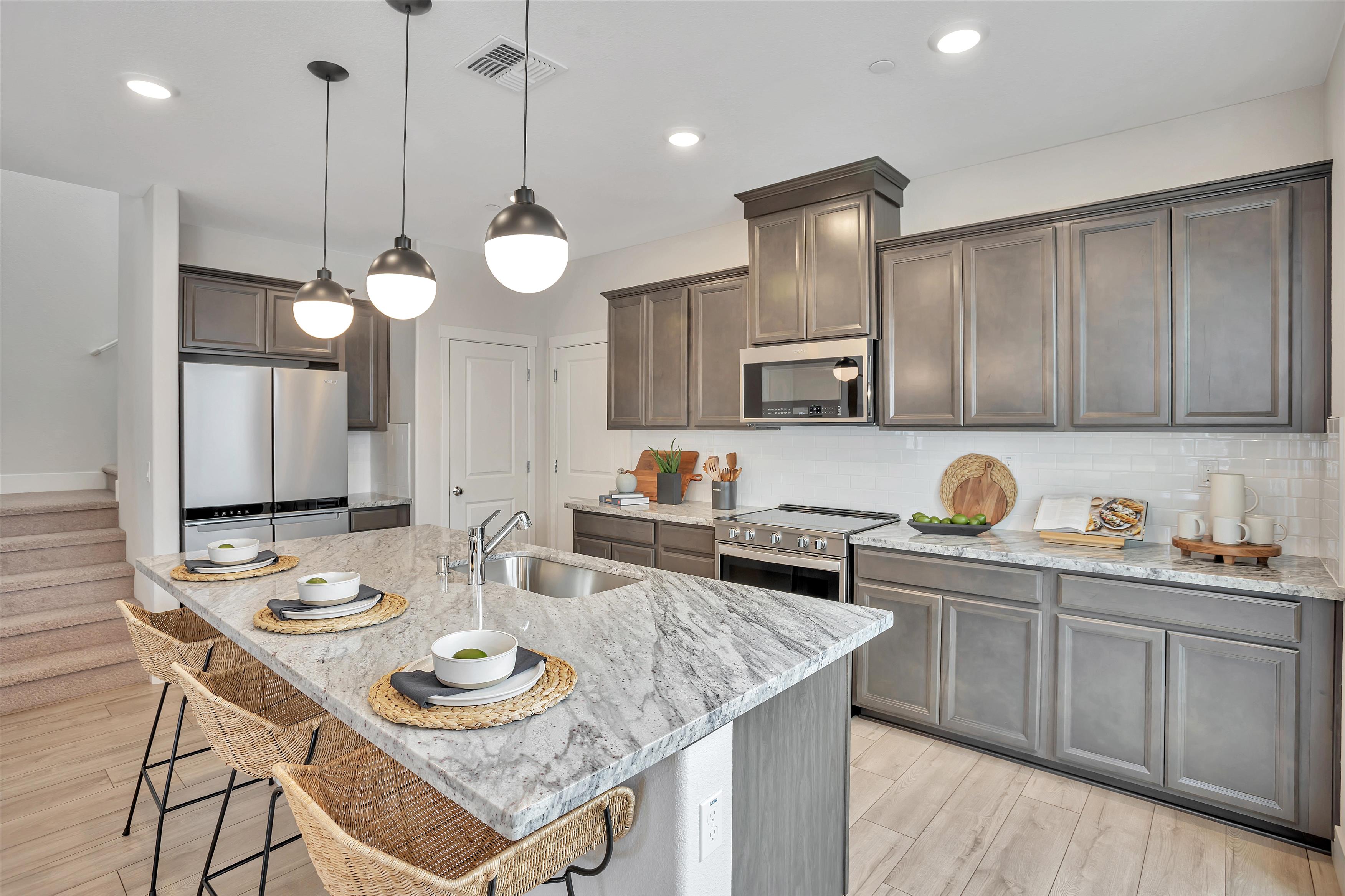 A kitchen with a table and chairs.