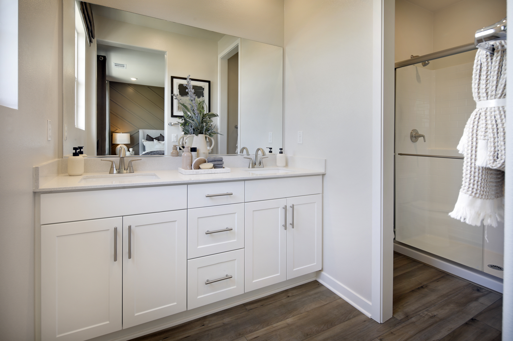 A bathroom with white cabinets.