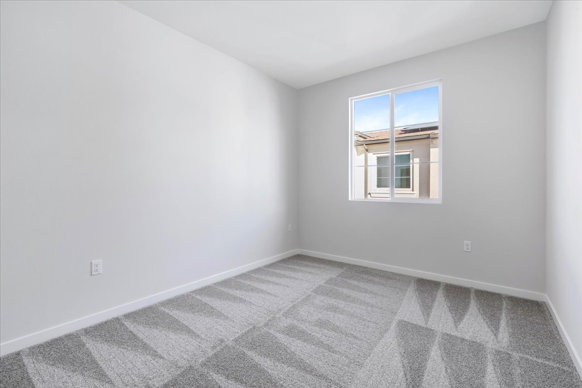 A room with a window and tile floor.