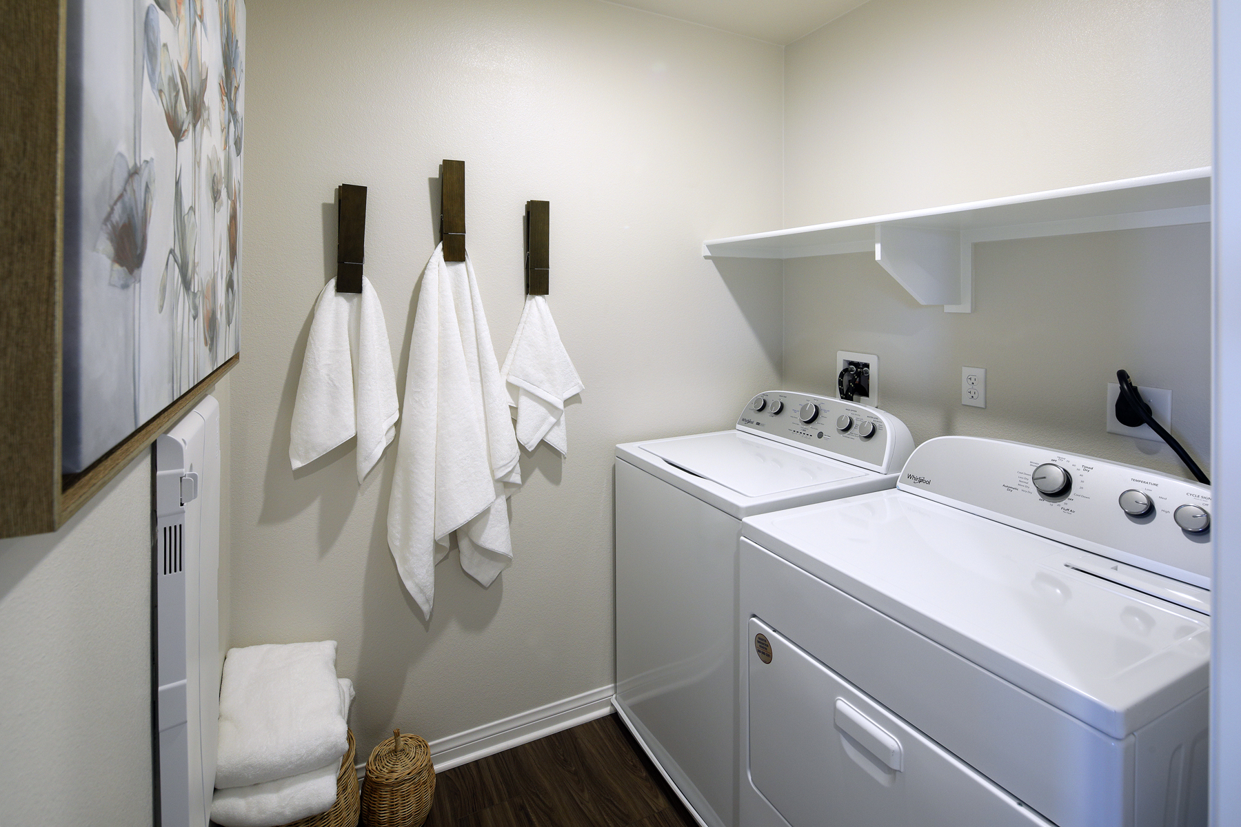 A white kitchen with a white stove and white cabinets.