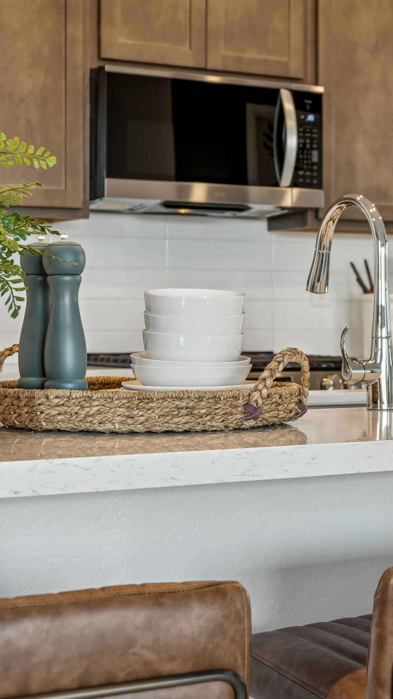 Photo of Kitchen with Burlap upgraded cabinets, brushed nickel hardware and kitchen island with barstools in Casa Grande AZ- New Construction Home For Sale by Century Communities with community amenities
