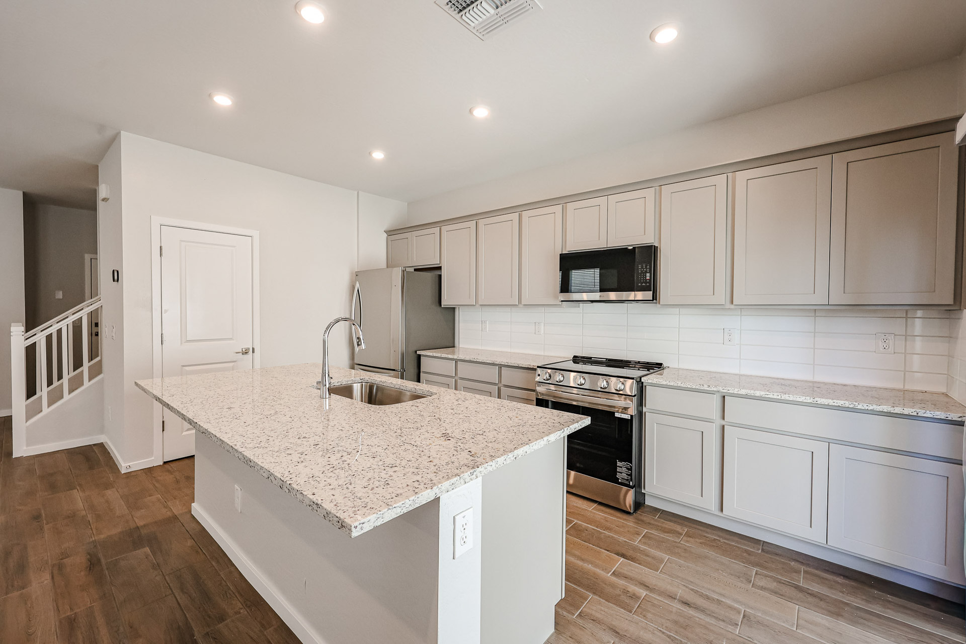 A kitchen with white cabinets.