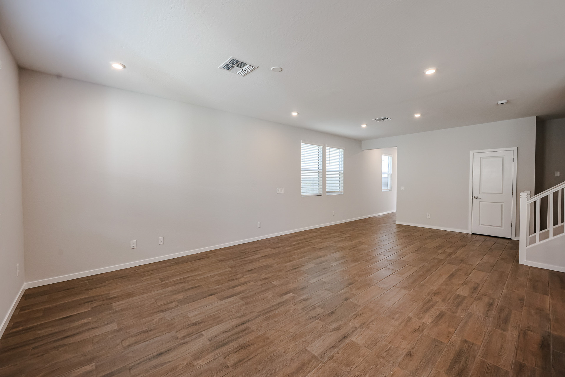 A room with a wood floor and a wood floor.