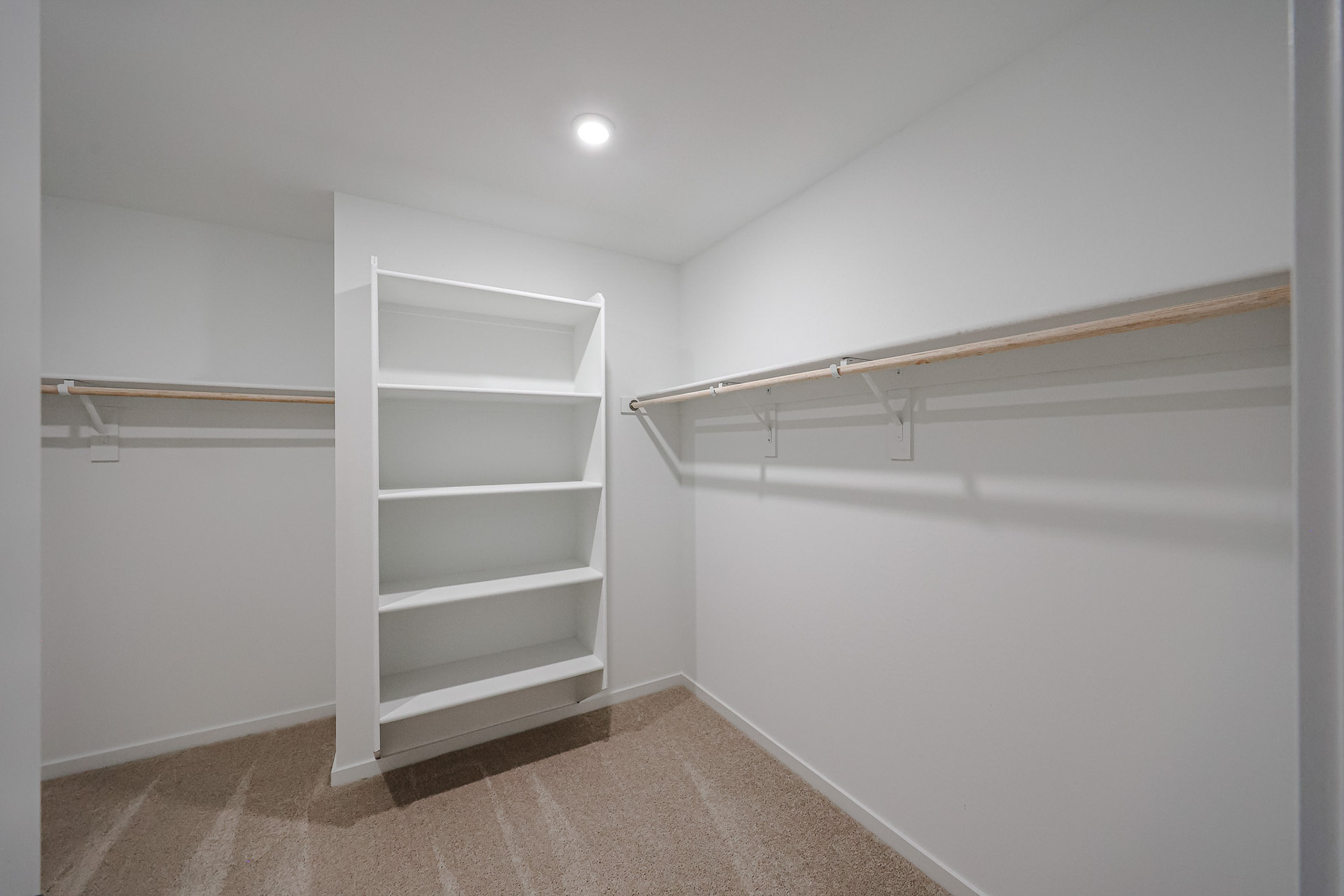 A white shelf in a room.