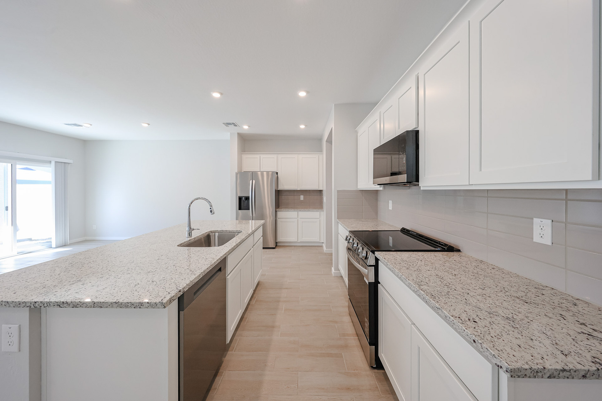 A kitchen with white cabinets.