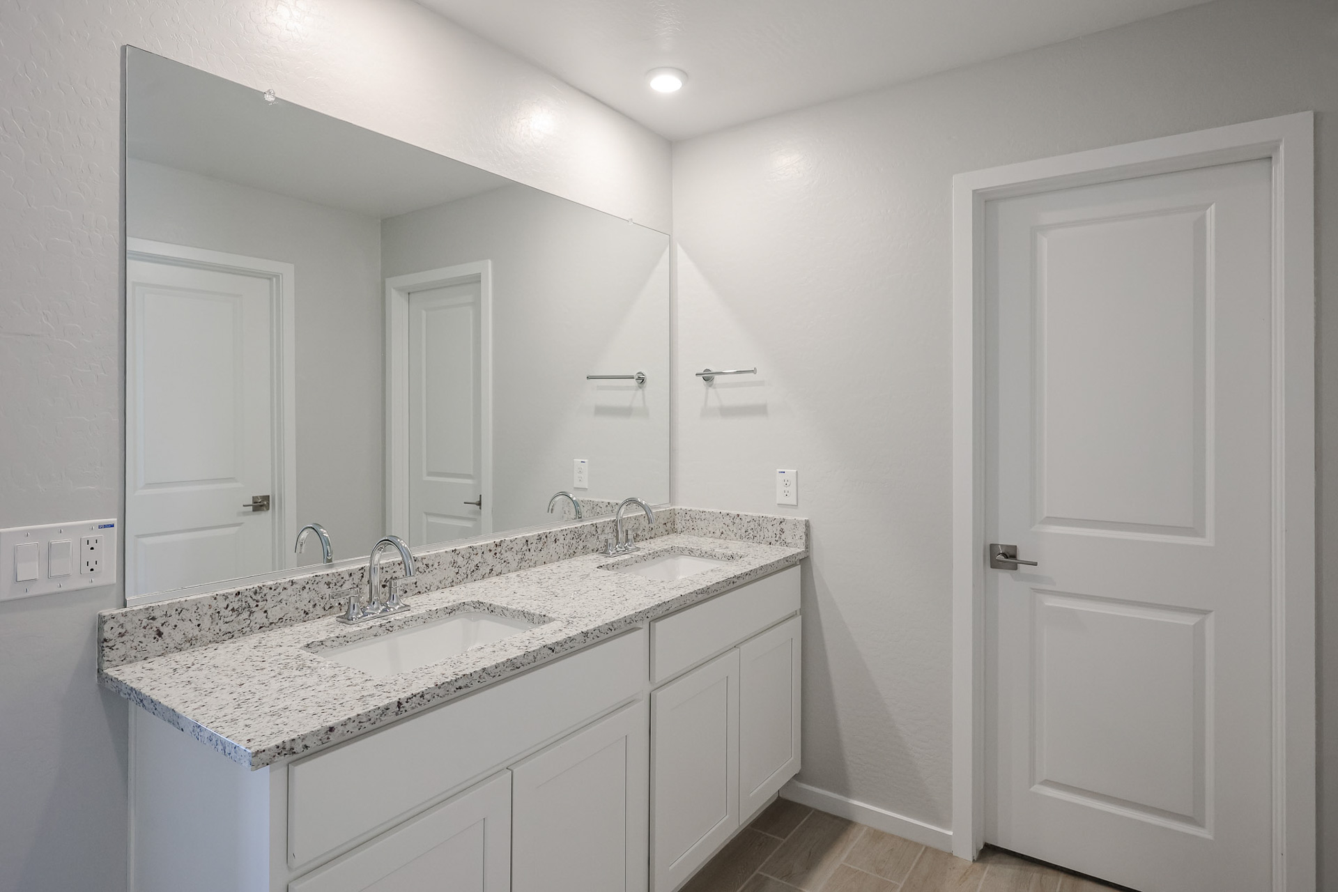 A bathroom with a marble countertop.