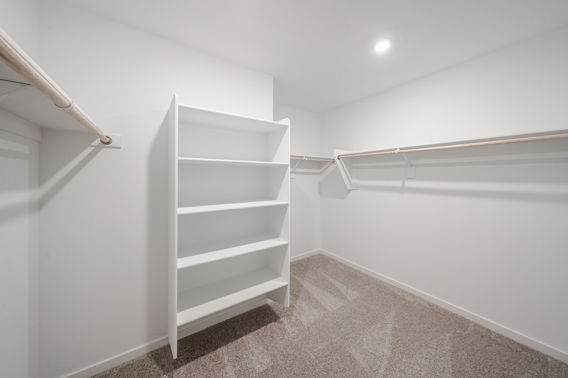 A white room with a white shelf.