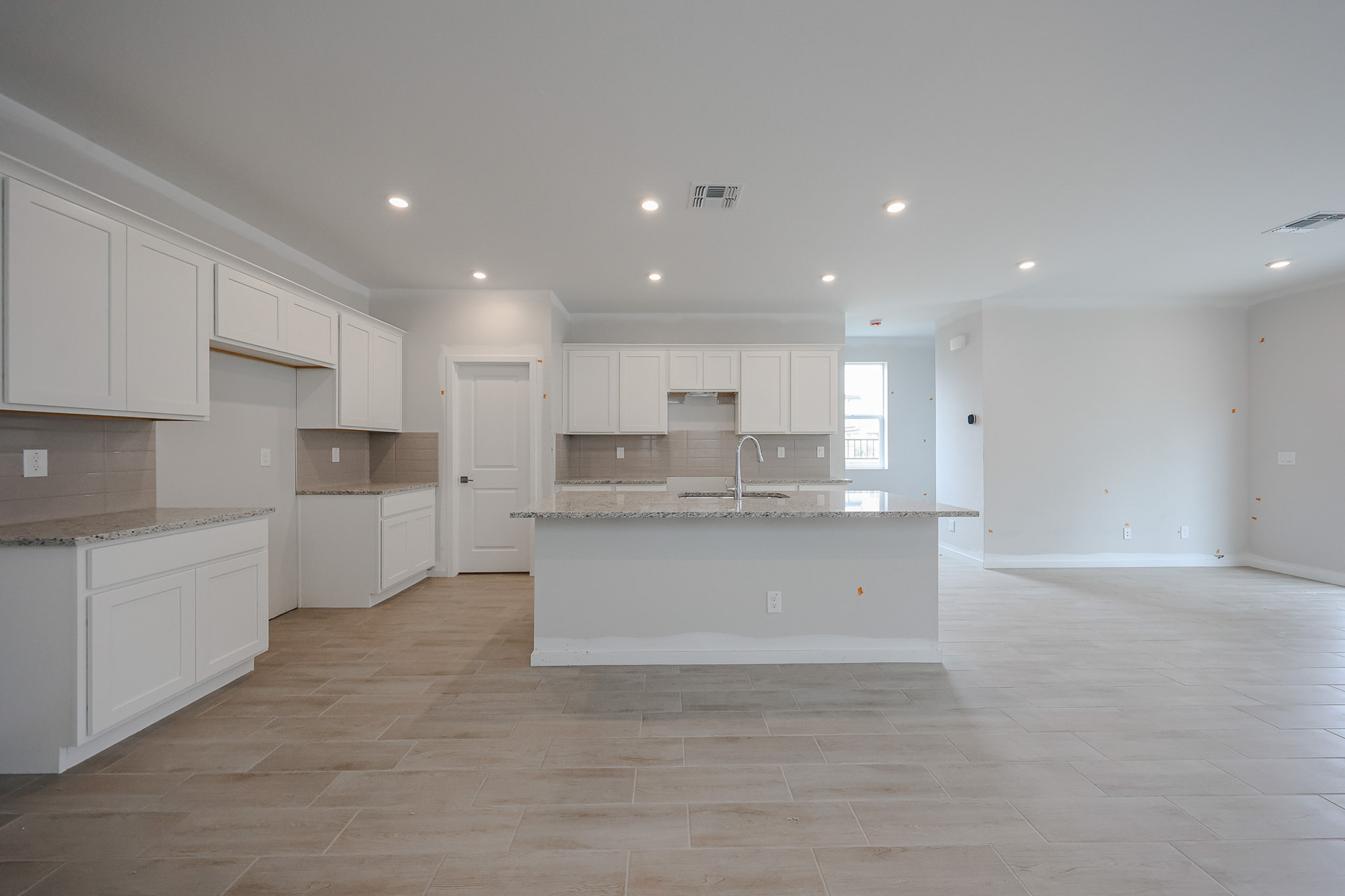 A kitchen with white cabinets.