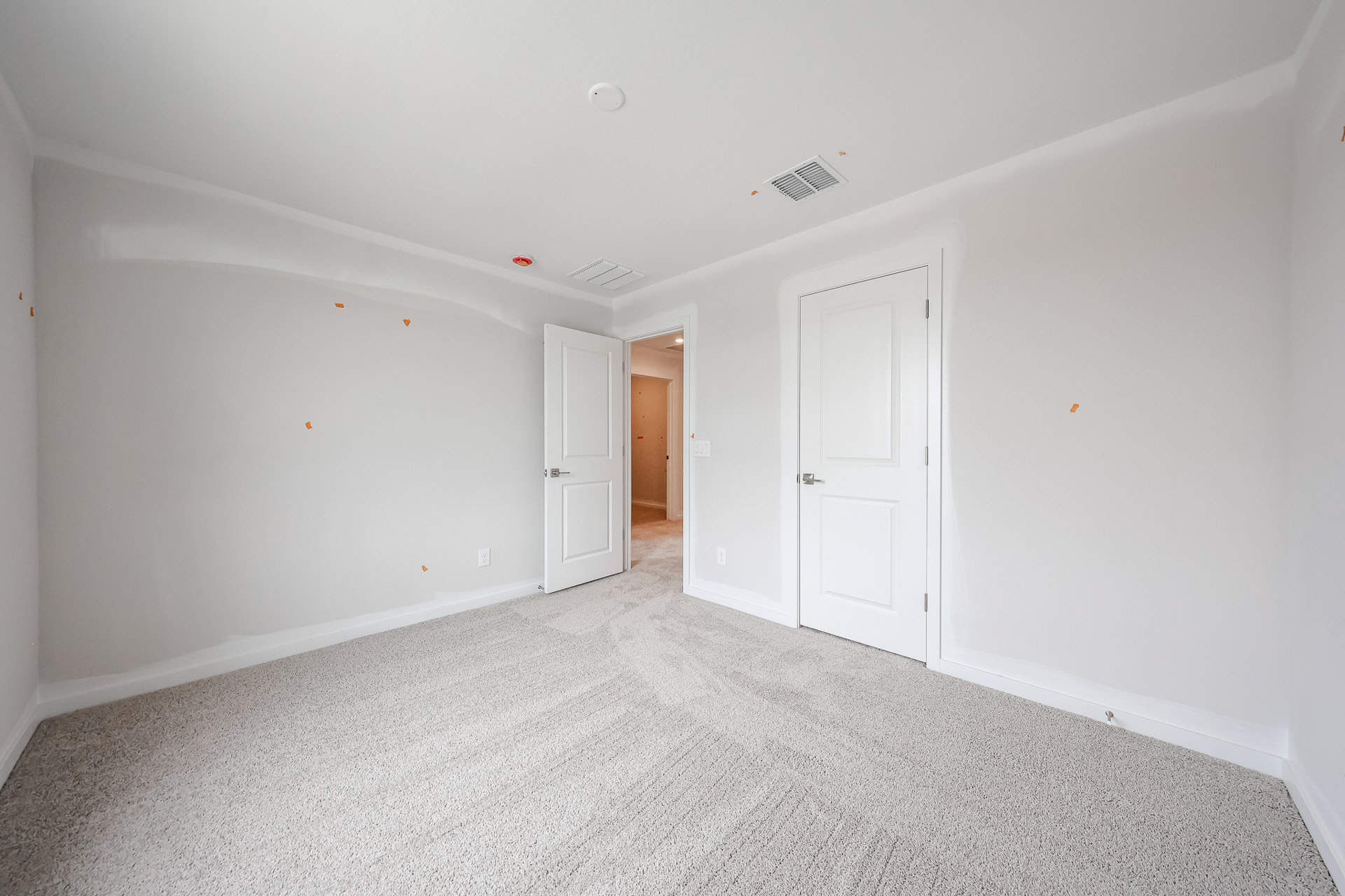 A hallway with white doors.