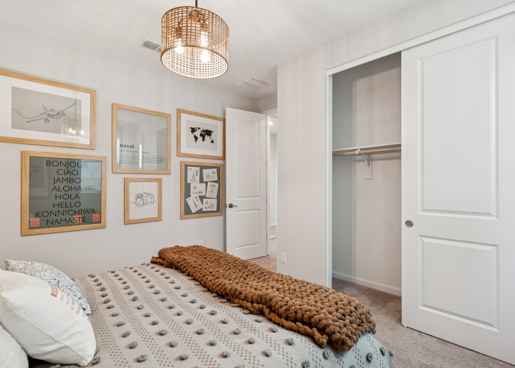 A bedroom with a bed and a lamp.