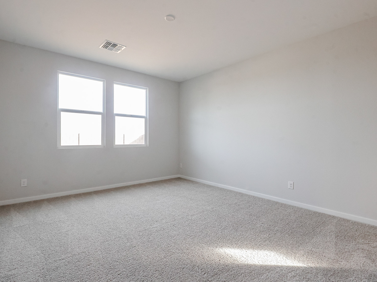 A room with a window and a carpet.