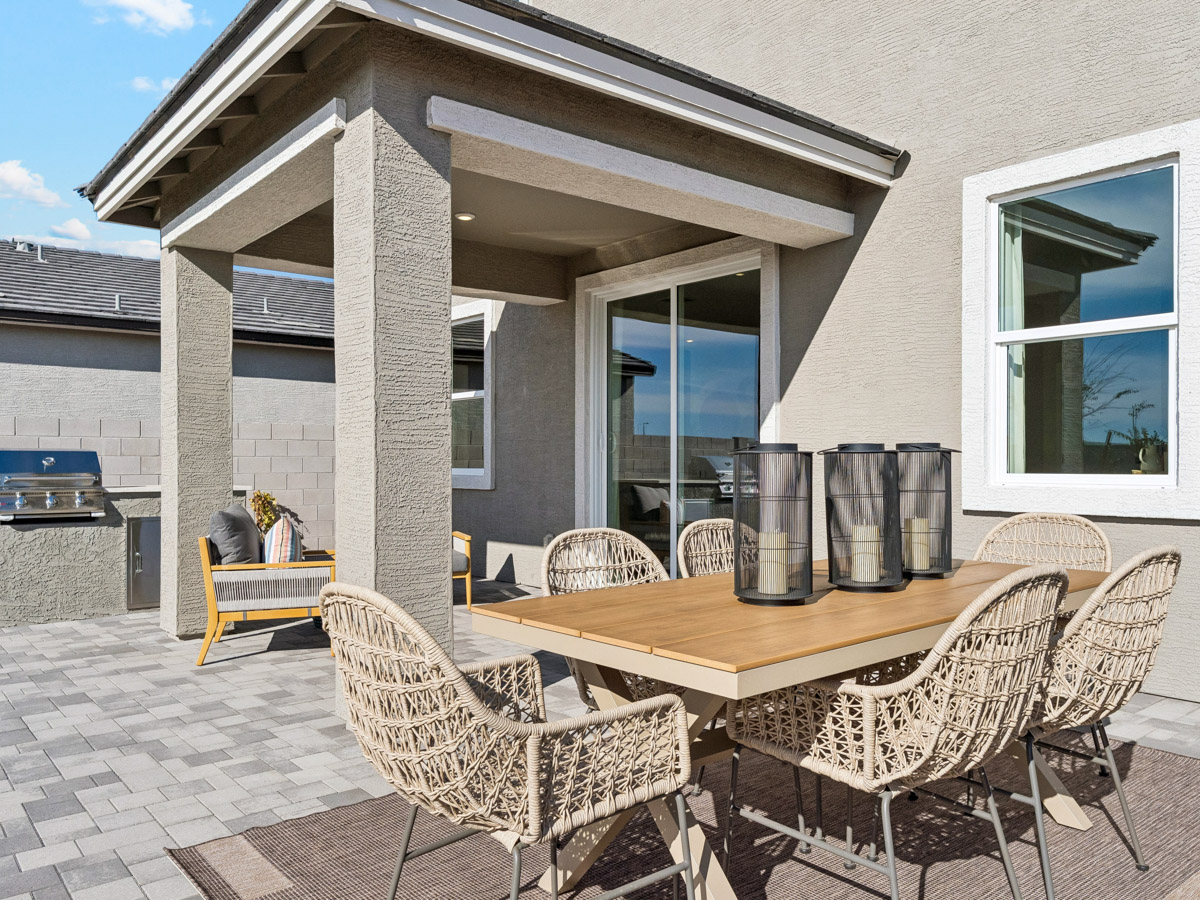 A table and chairs outside a house.