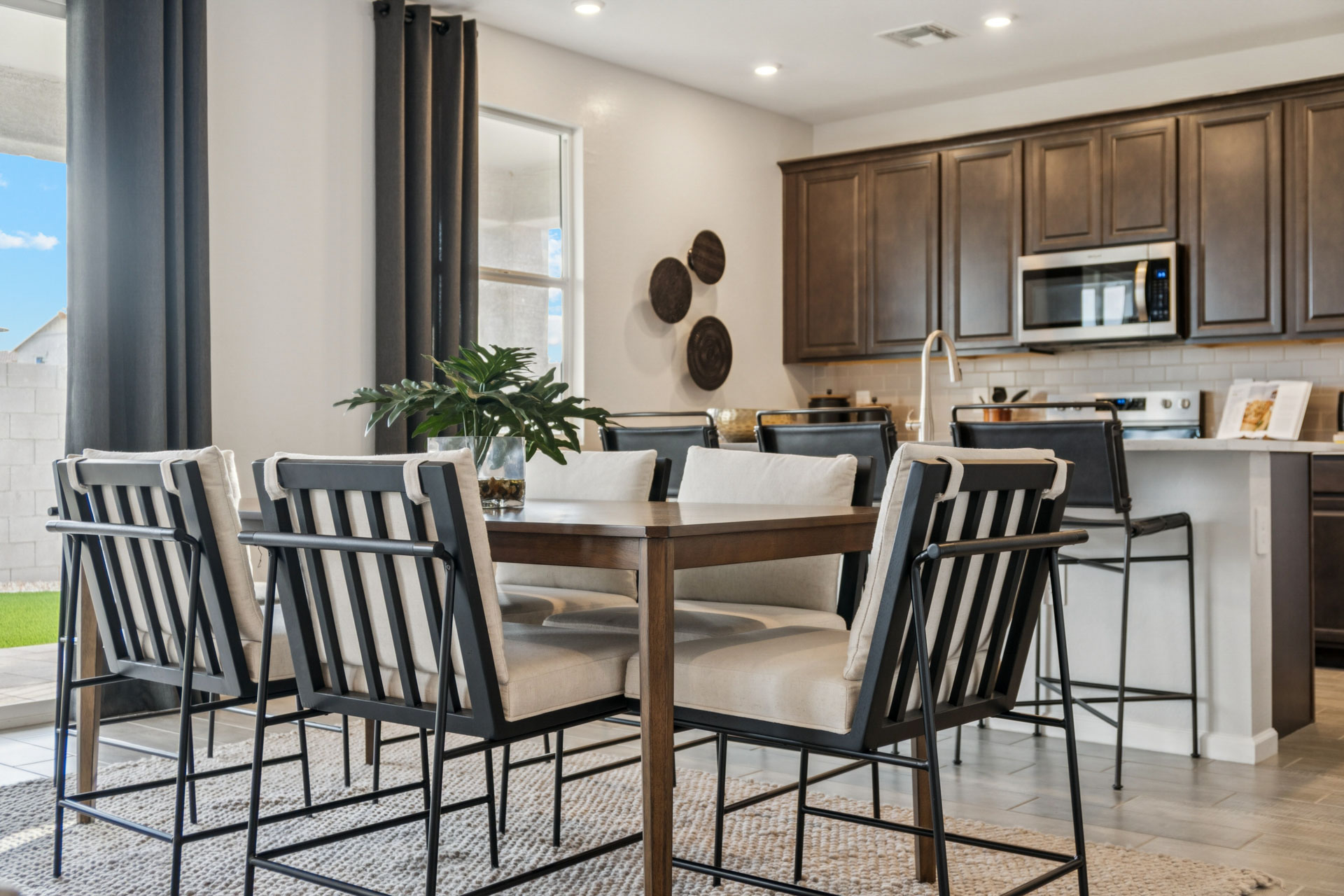 A kitchen with a table and chairs.