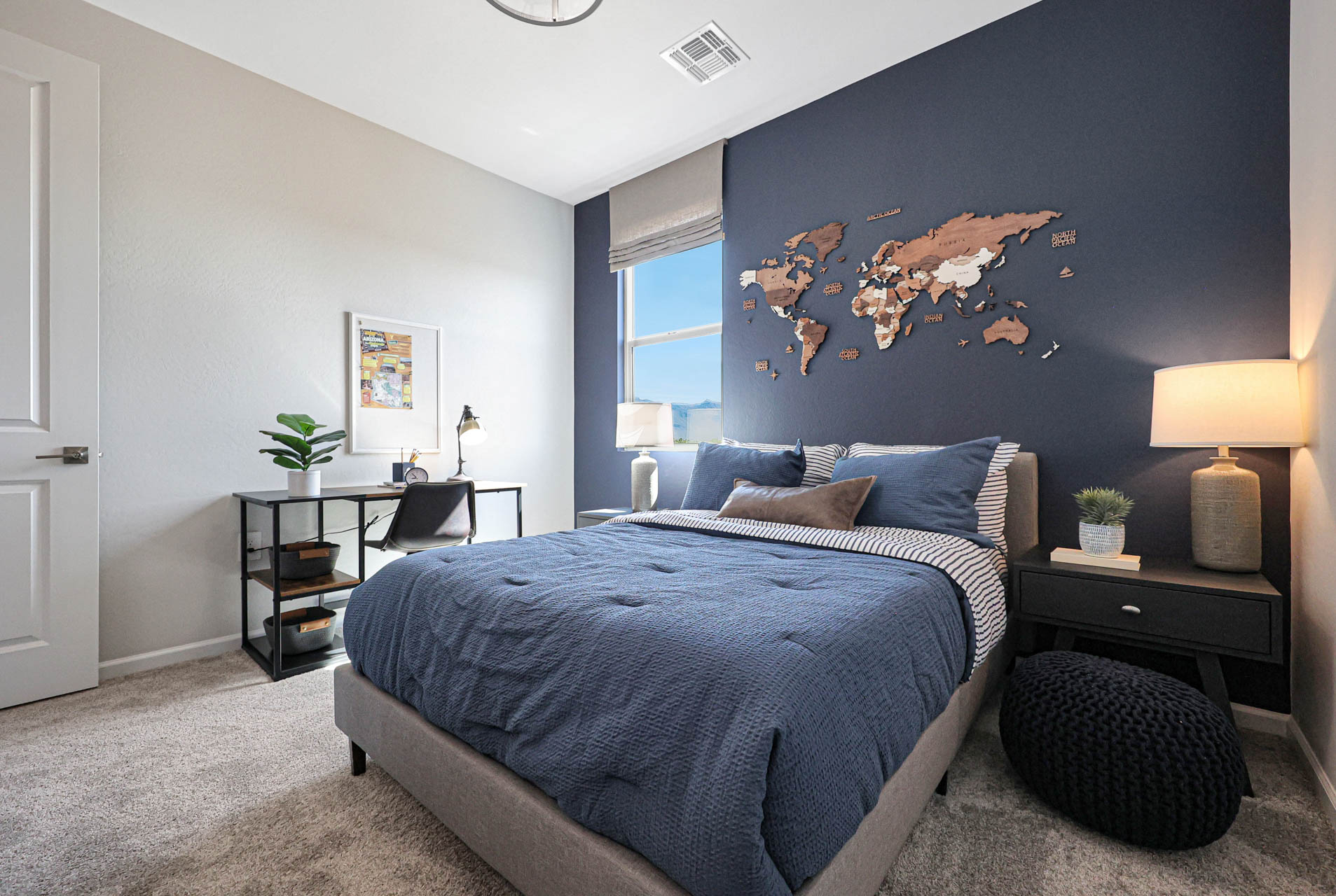 A bedroom with a bed and a desk.