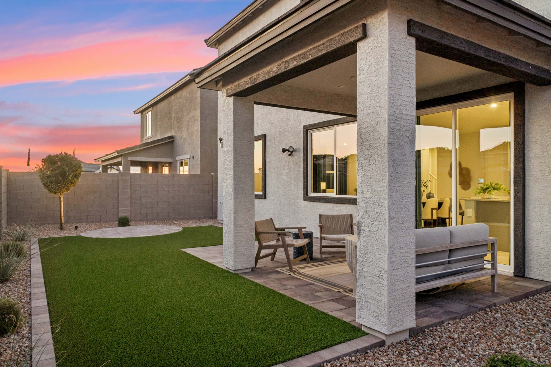 A house with a pool and a large front yard.
