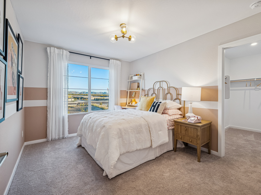 A bedroom with a bed and a window.