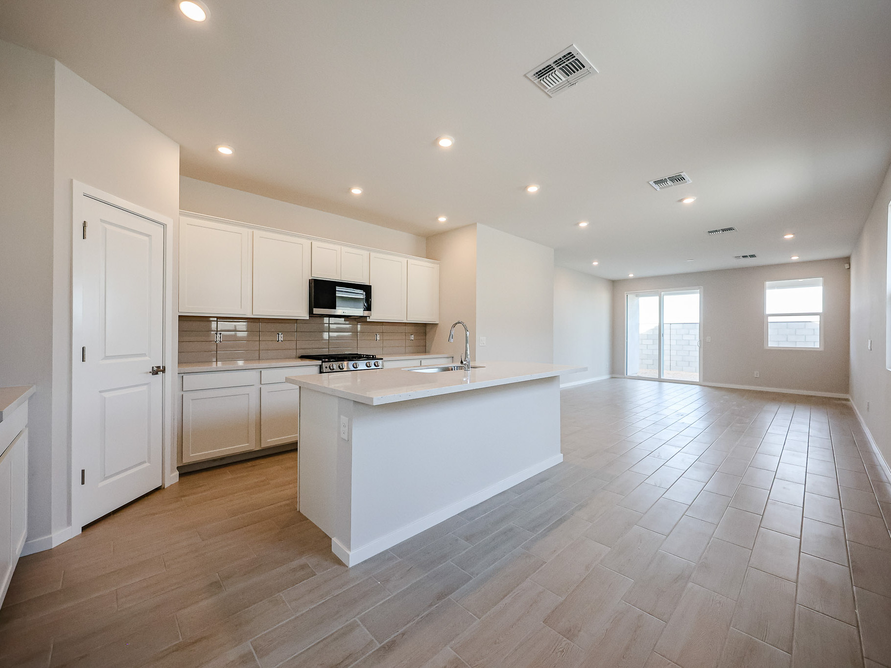 A kitchen with white cabinets.