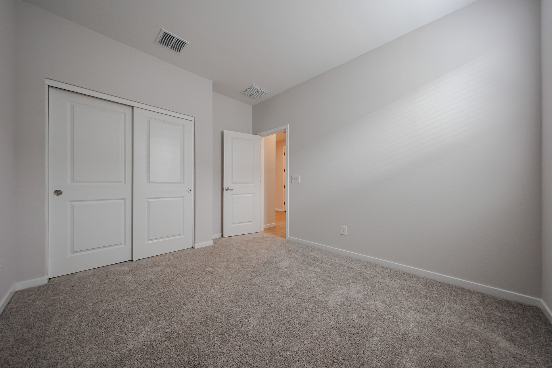 A hallway with white doors.