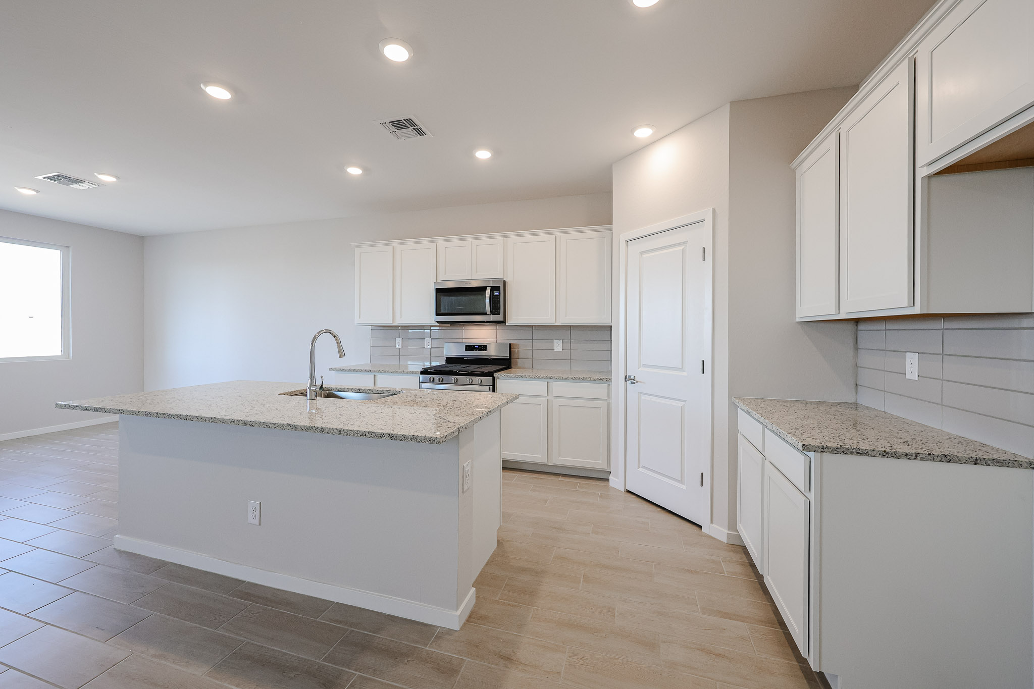 A kitchen with white cabinets.