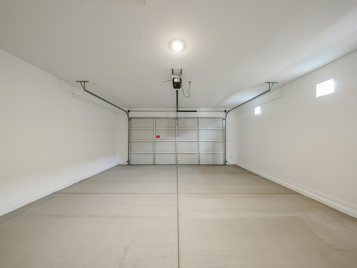 A white room with a metal gate.