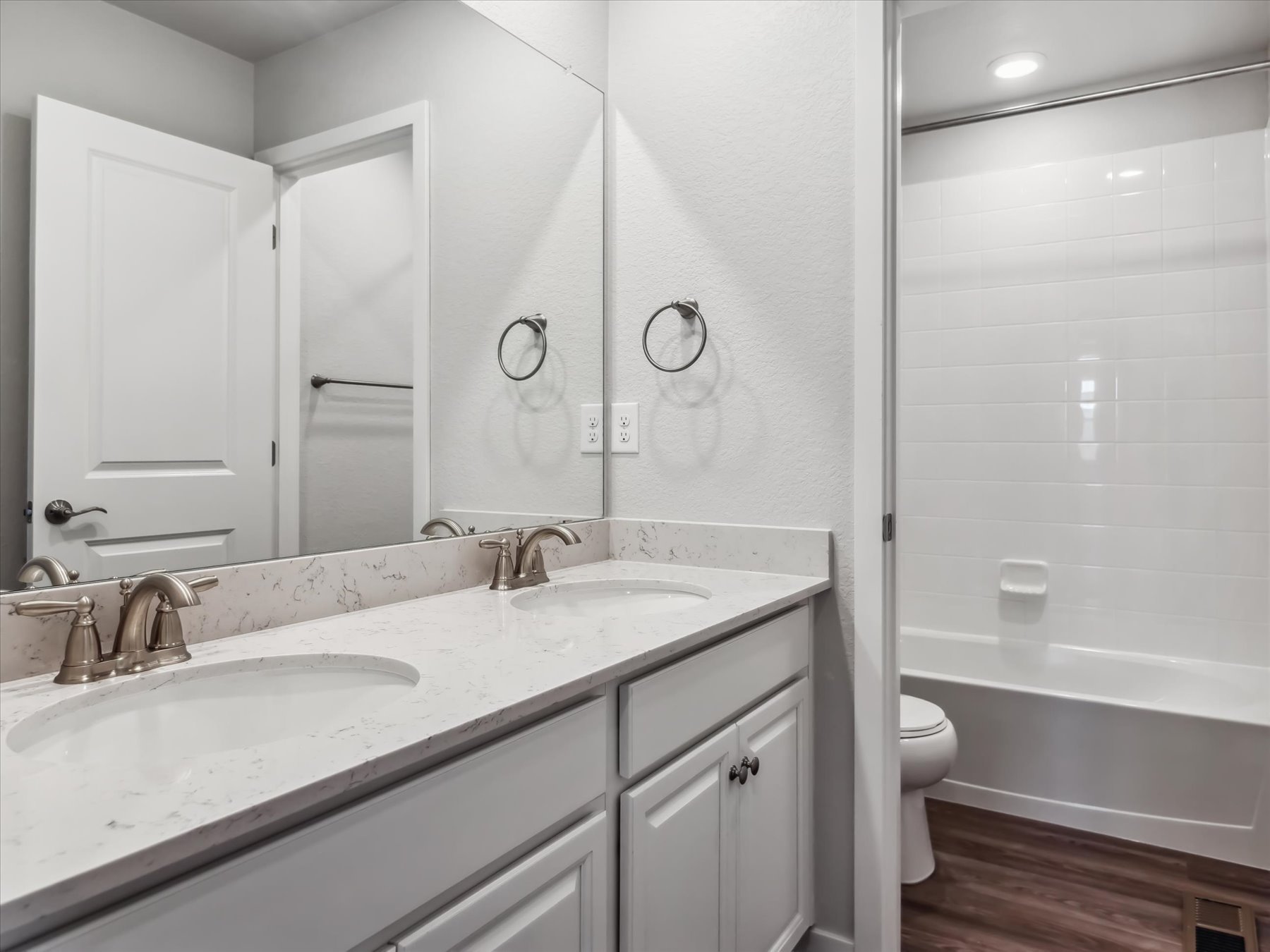 A bathroom with a sink toilet and bathtub.