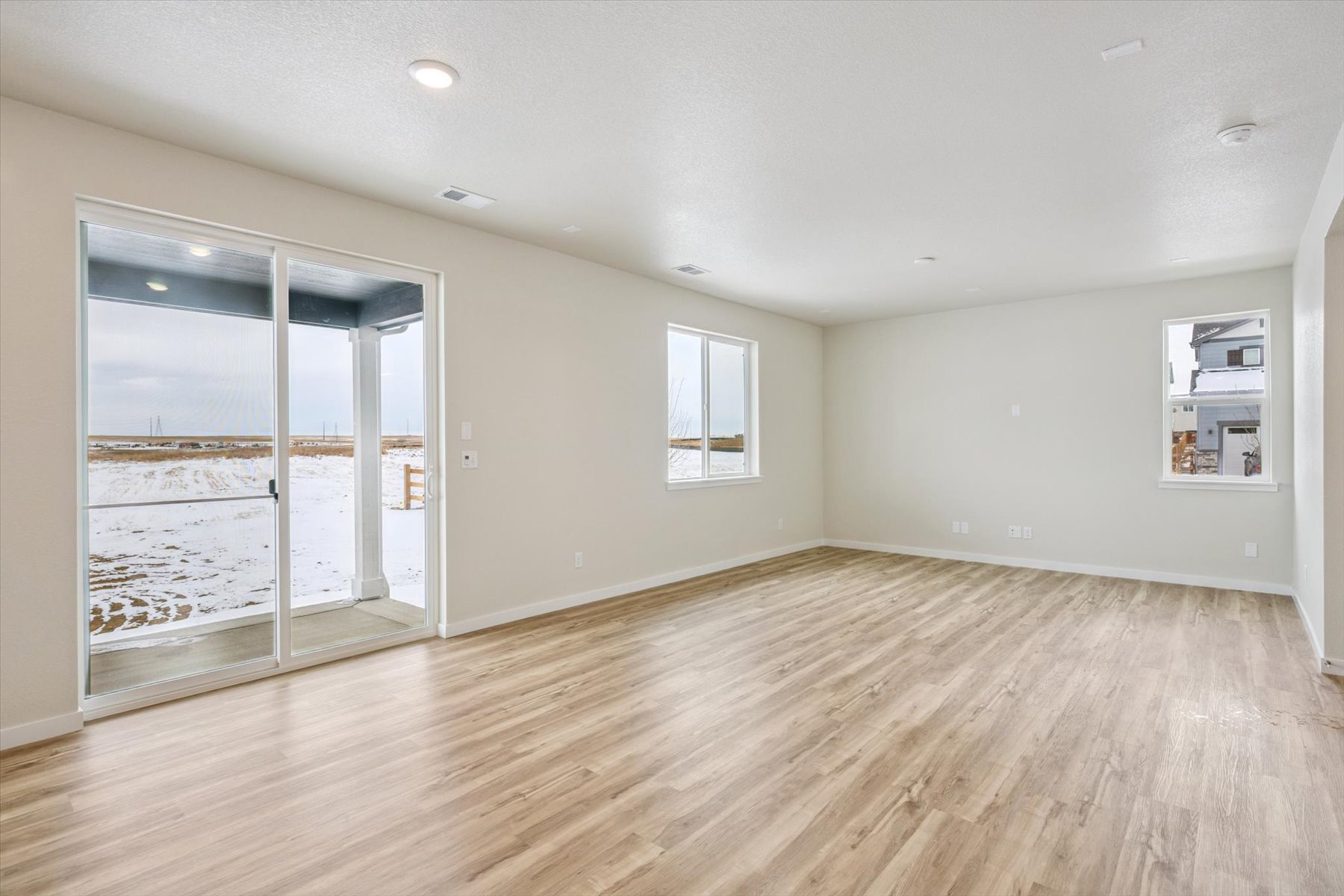A room with a wood floor and a glass door.