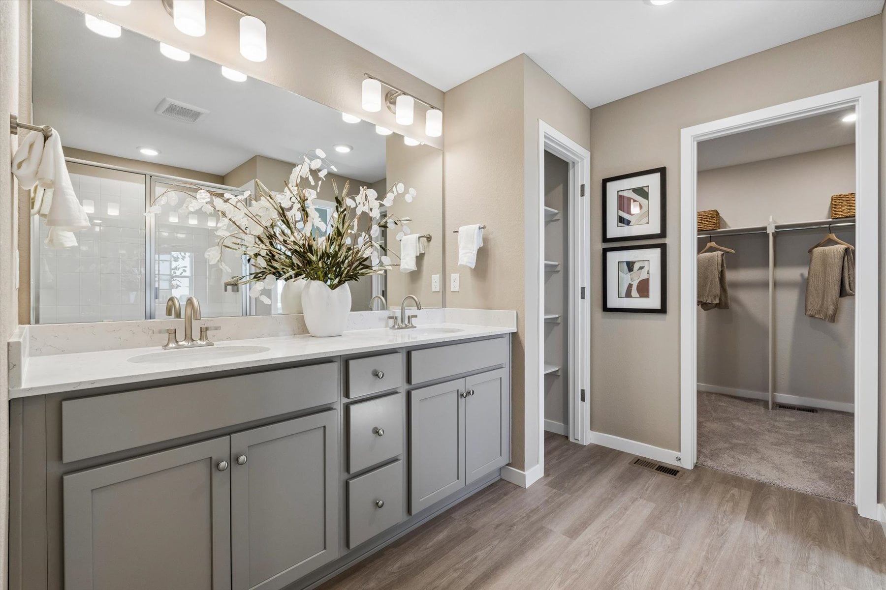 A bathroom with a large mirror.