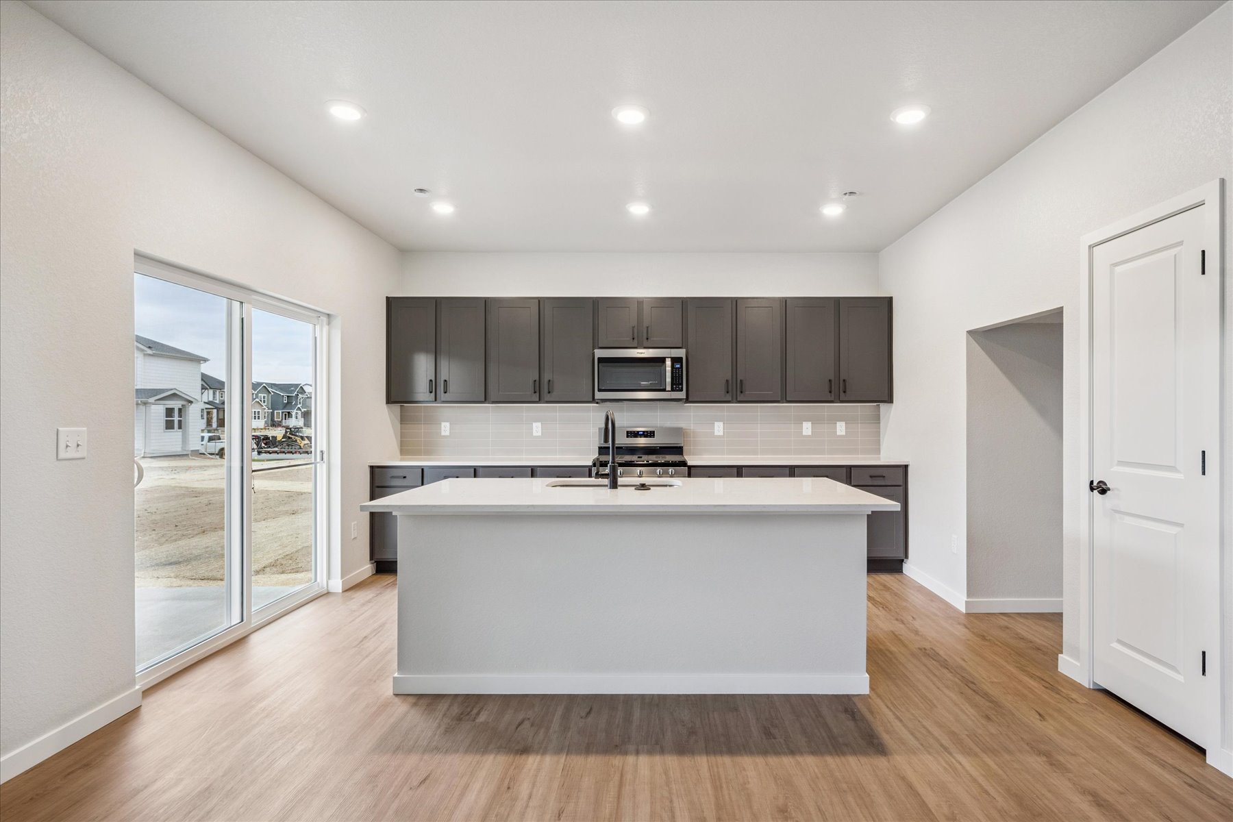 A kitchen with a large glass door.