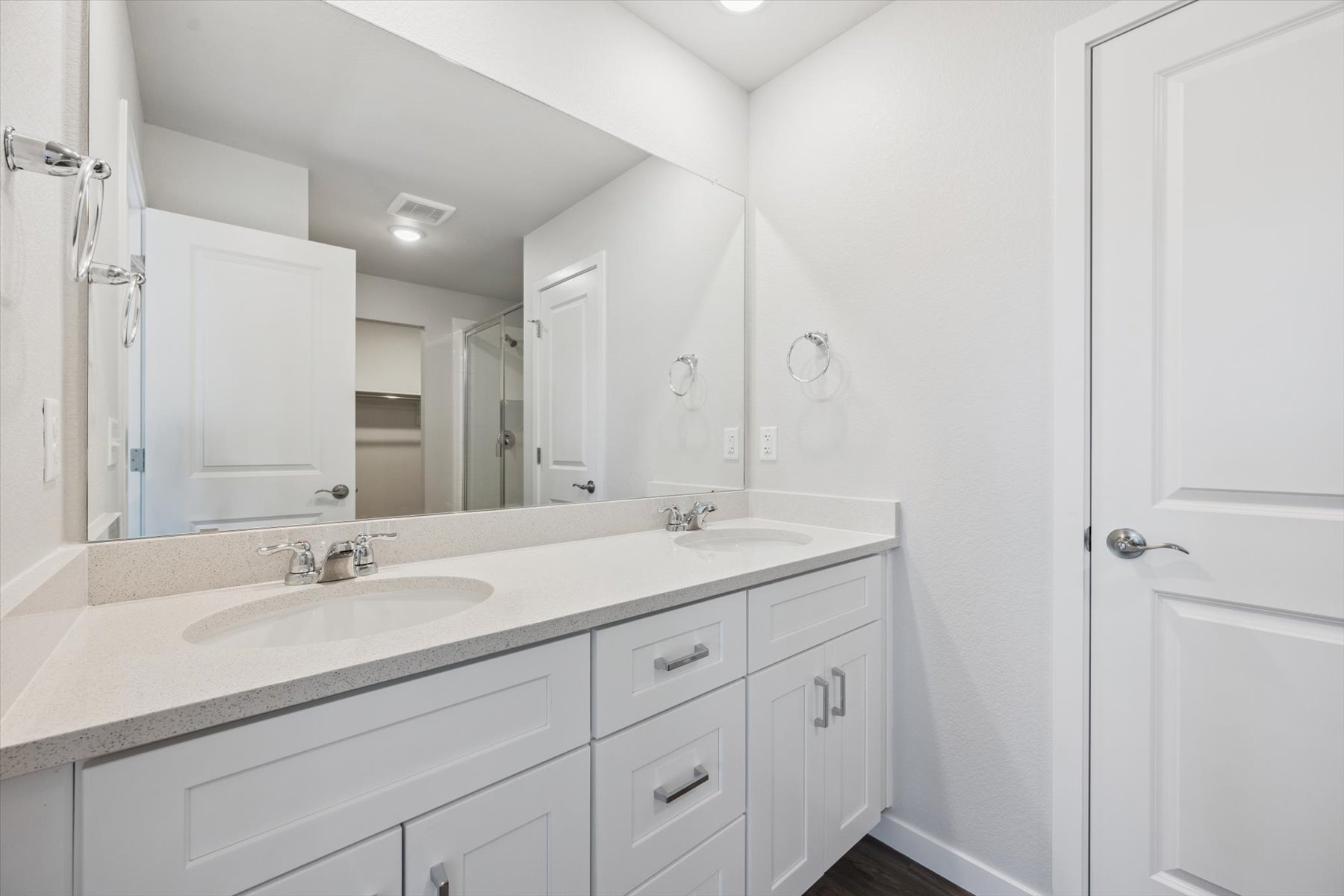 A bathroom with a large mirror.