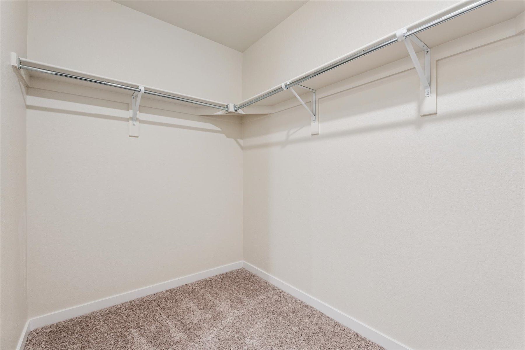 A white wall with a metal railing.