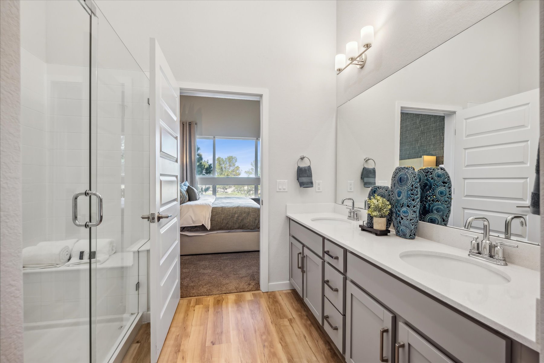 A bathroom with a tub sink and a mirror.