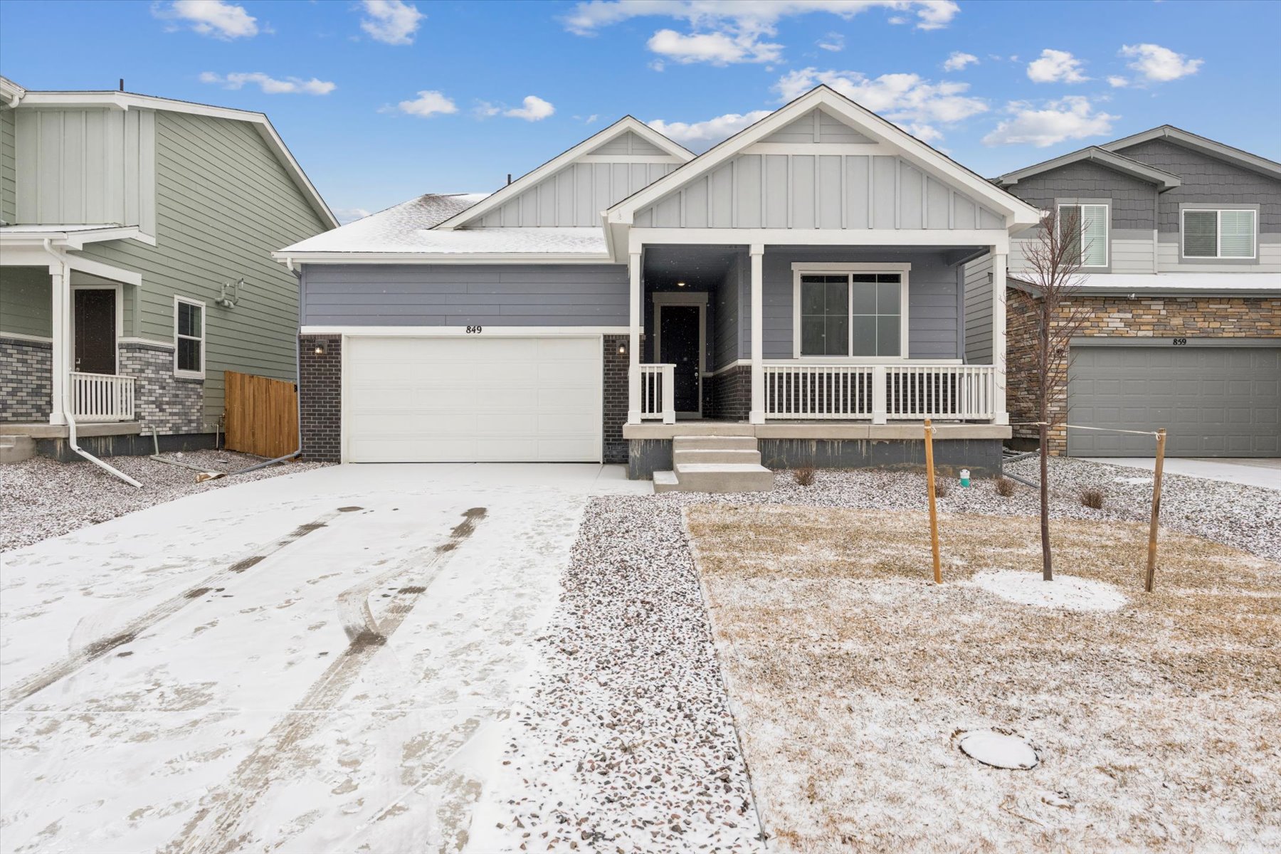 A house with a garage and a fence in the front.