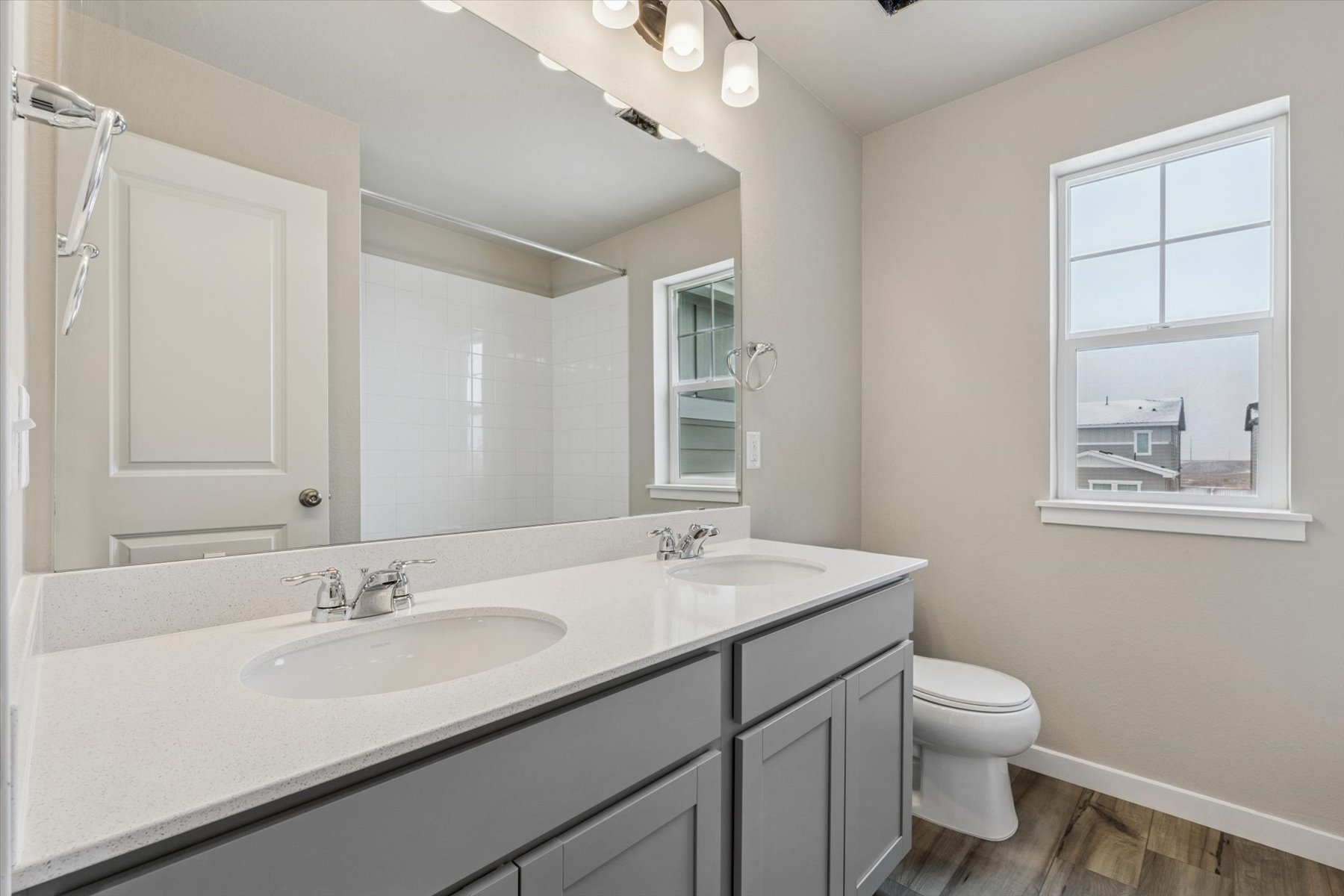 A bathroom with a large mirror.
