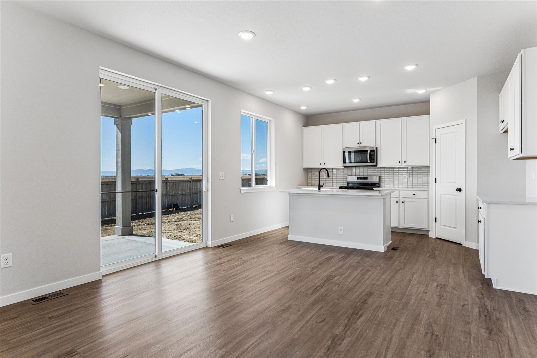 A large kitchen with white cabinets.