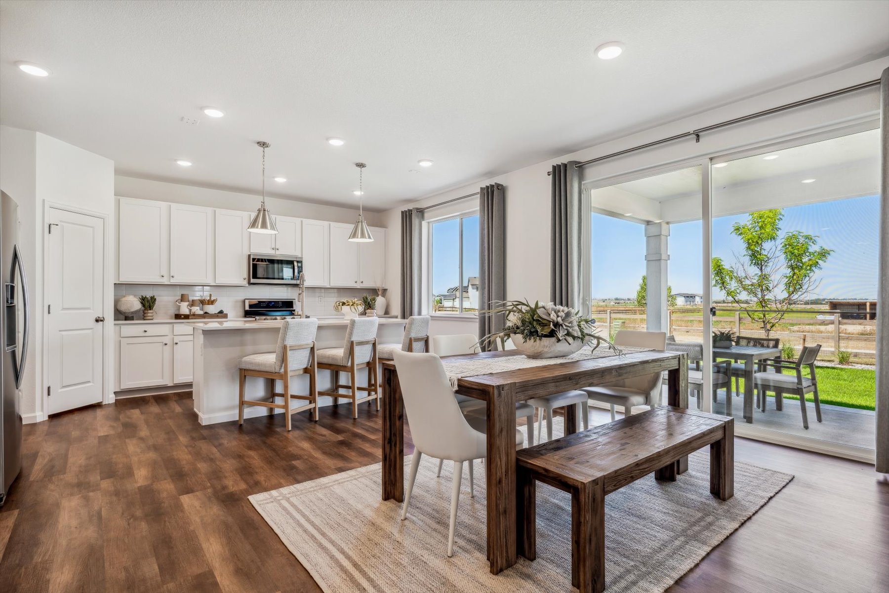 A kitchen with a dining table and chairs.