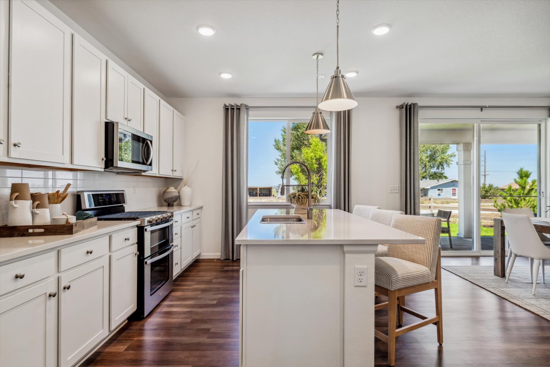 A kitchen with white cabinets.