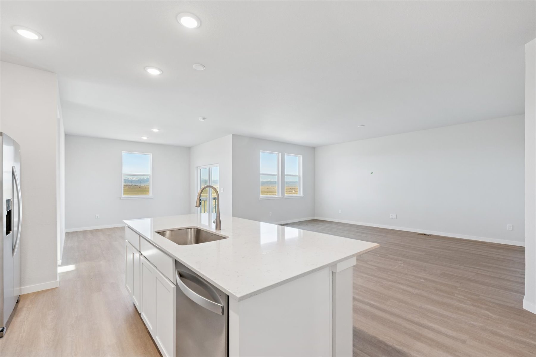 A kitchen with white cabinets.