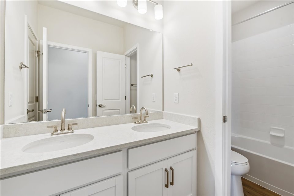 A bathroom with a large mirror.