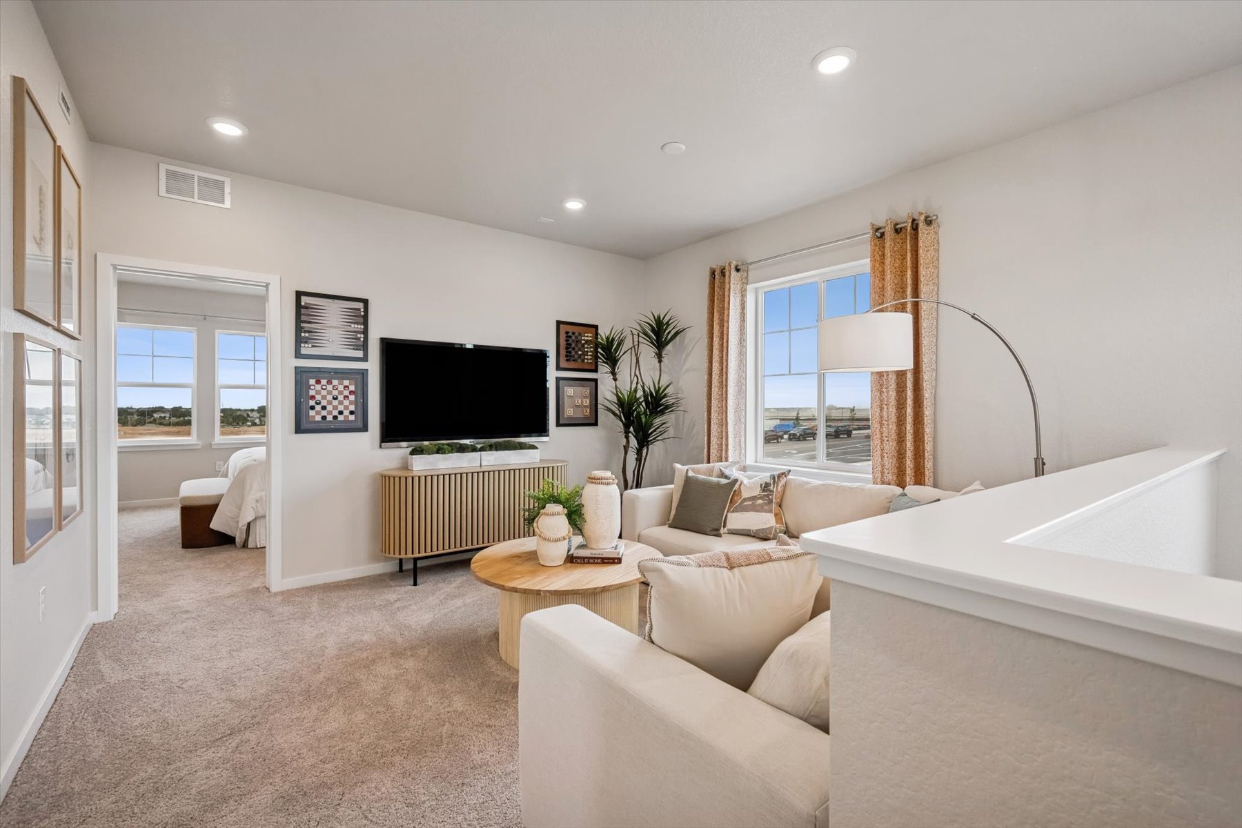 A living room with a bed and a tv.