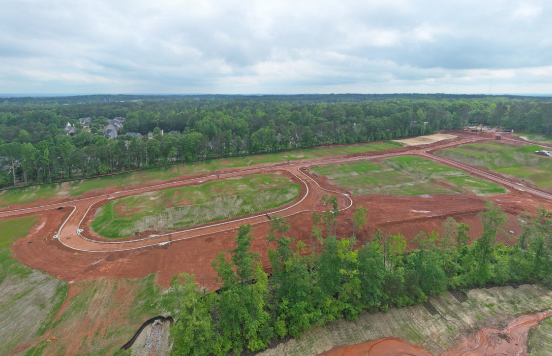 A landscape with trees and a road.