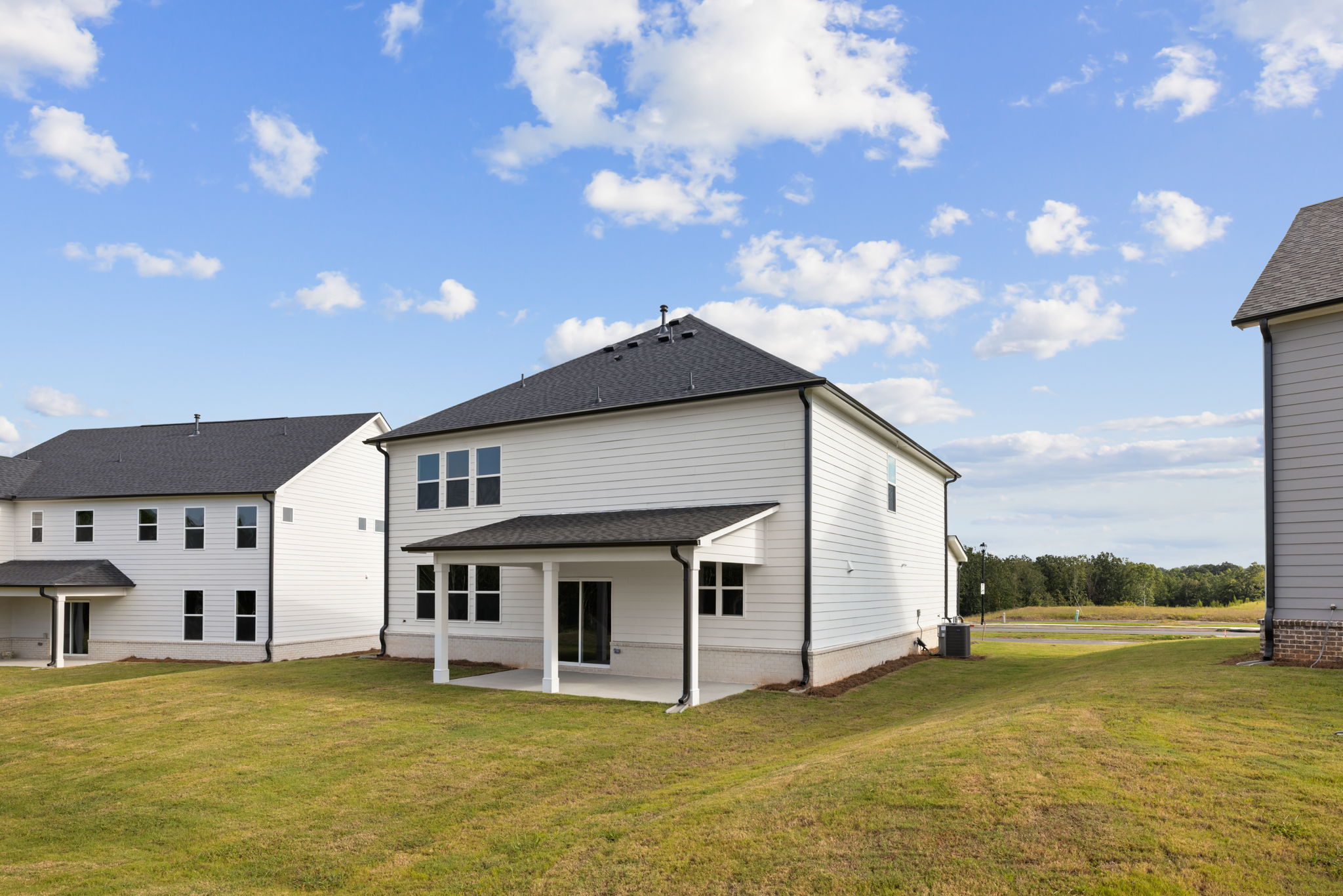 A white house with a grass yard.