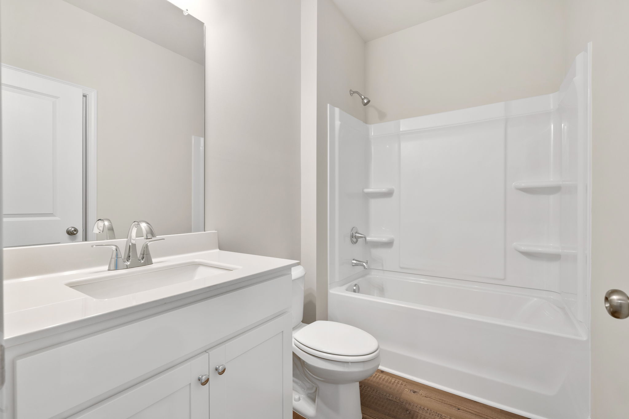 A bathroom with a tub sink and toilet.