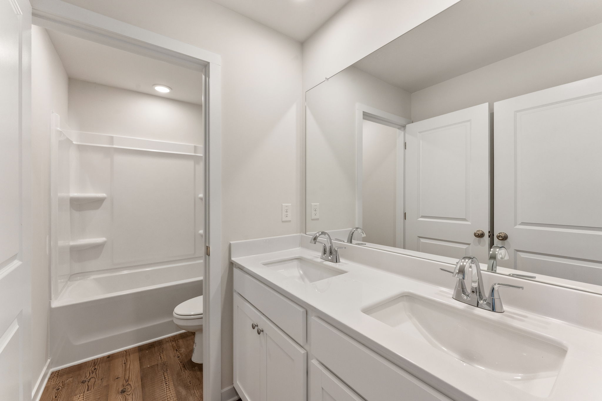 A bathroom with a tub sink and toilet.