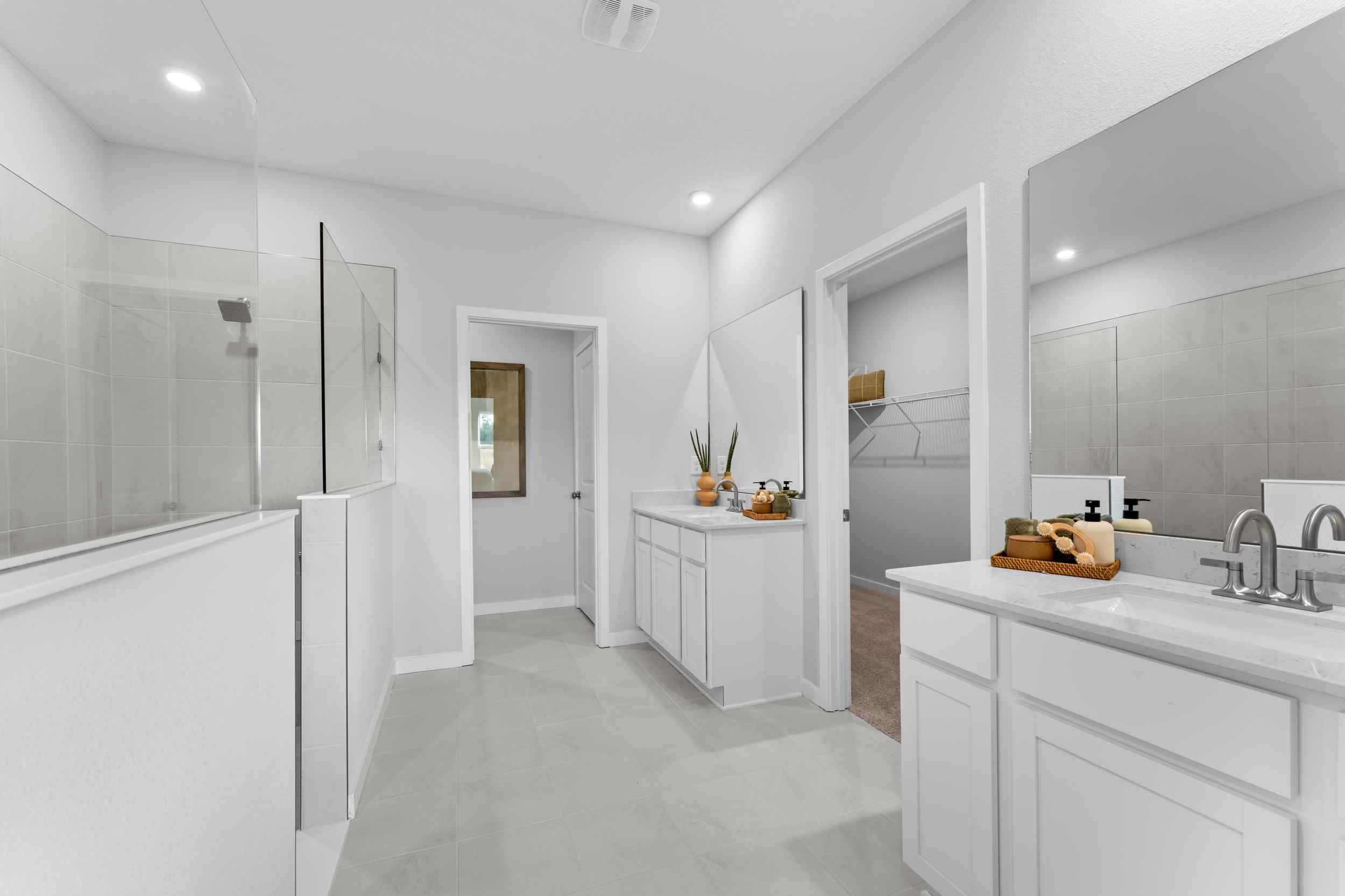 A bathroom with white cabinets.