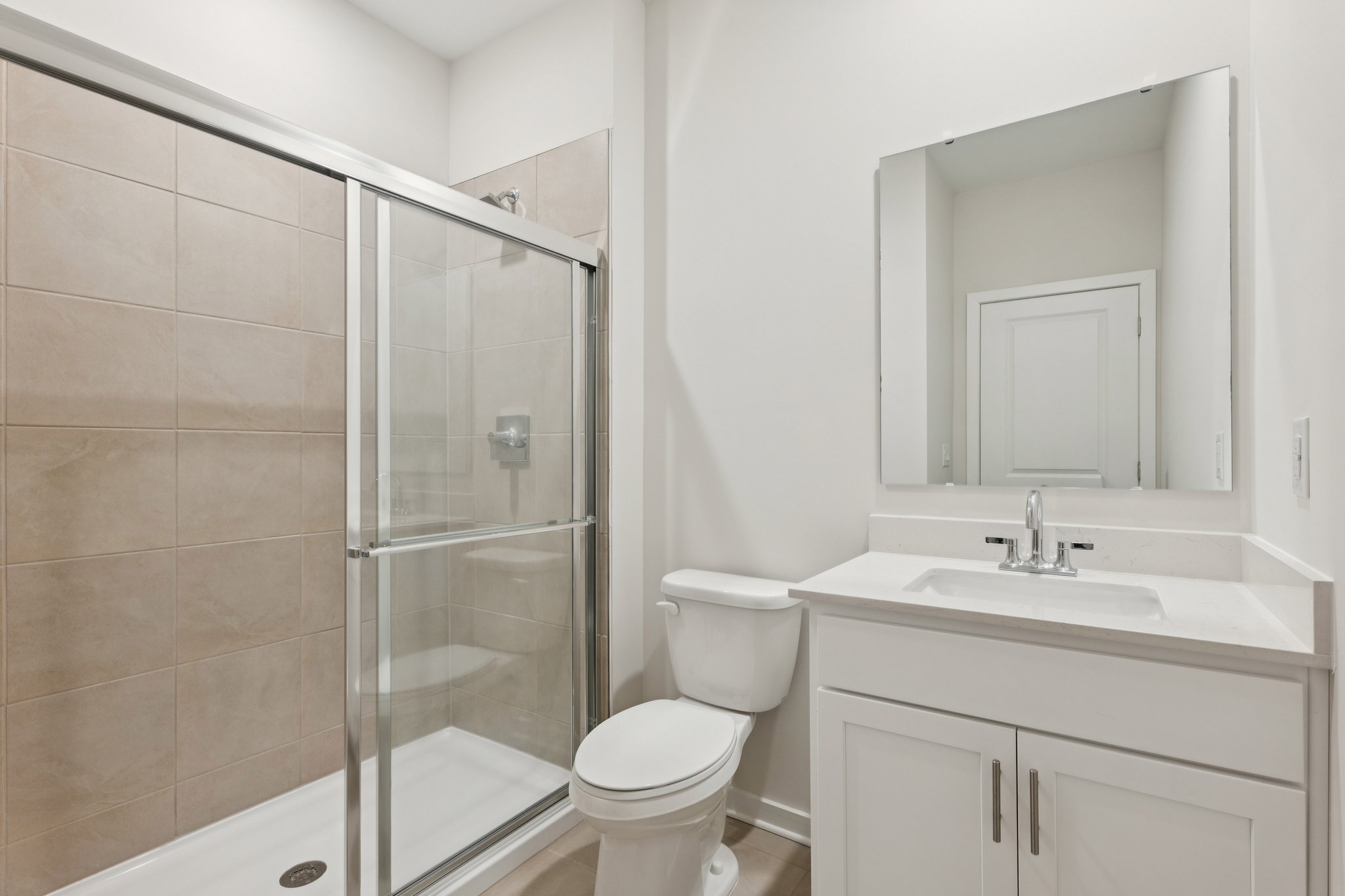 A bathroom with a glass shower.