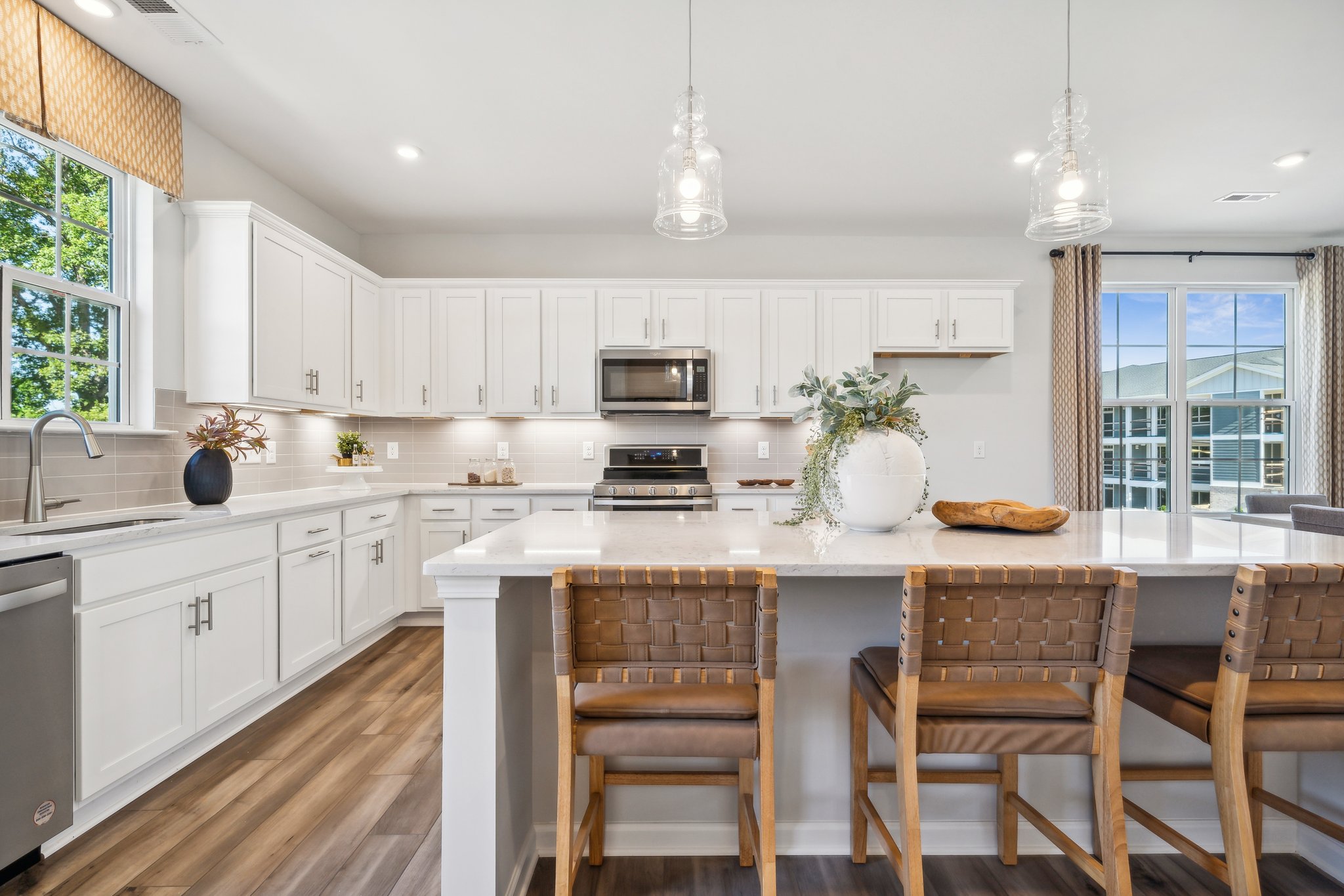 A kitchen with a table and chairs.